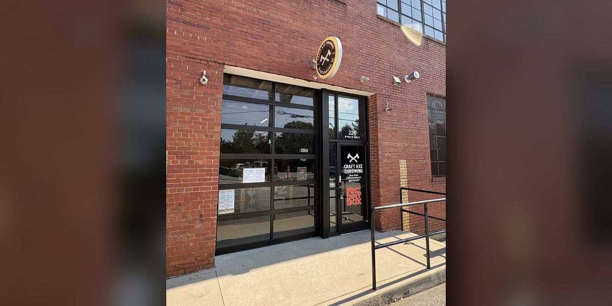 The Craft Axe Throwing Spartanburg entrance at 226 W Main St, Suite D, with the RC Dirt Box decal on the door