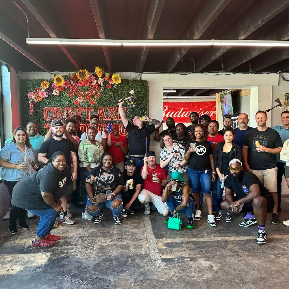 Large group celebrating around the throwing lanes at Craft Axe Throwing Fort Mill in historic downtown Fort Mill